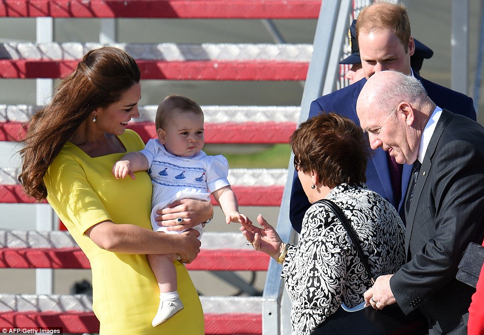 Glowing mum: The 32-year-old stood out from the crowd as she introduced Prince George to Lynne Cosgrove, centre right, the wife of Australia's Governor-General Peter Cosgrove, far right