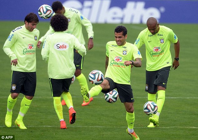 Keep up: Dani Alves (second right) also got a taste of the official World Cup ball at Granja Comary