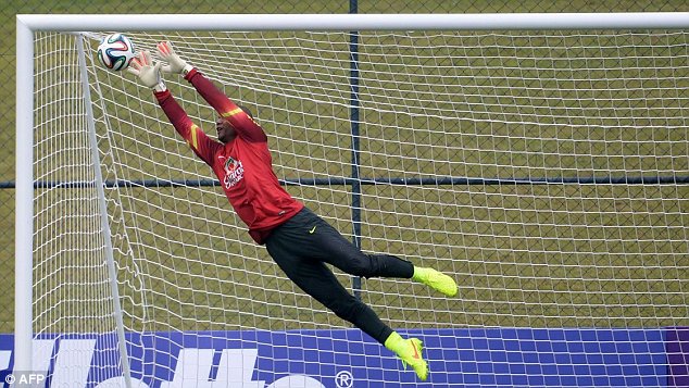 Back of the net: Goalkeeper Jefferson stretches for the ball but can't prevent a goal during training