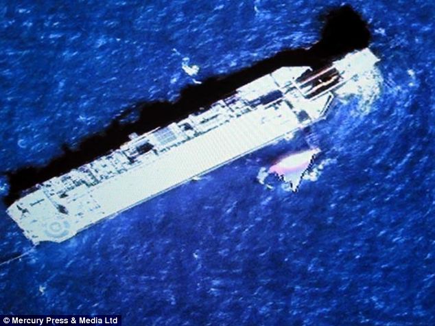 Satellite image shows an oil rig next to a piece of debris which Mr Akers believes could have come from the missing flight MH370