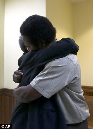 Reunion: Anderson embraces his grandmother Mary Porter after being released from custody on Monday
