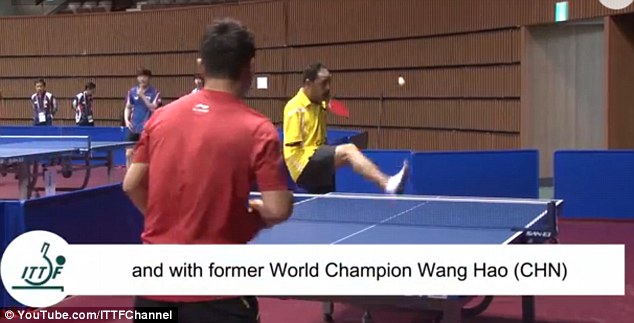 Inspirational: Mr Hamato serves against former world champion Wang Hao by flicking the ball up with his foot