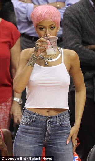 Good girl gone rad: Rihanna was on form in a cropped white vest top and skinny jeans