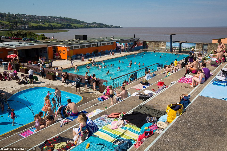Going outside: People enjoy the hot weather at Portishead Open Air Pool in Somerset, as the UK experiences continuing high temperatures
