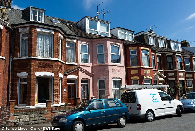 Before the journey: Ms James lived in the above pink house in Great Yarmouth for nine years, until she began moving from home to home in 2001