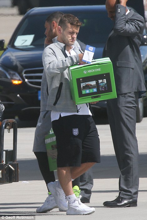 Jack Wilshere inspects his freebie on the tarmac at Luton Airport
