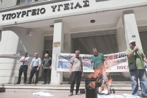 ΦΩΤΟ-Εργαζόμενοι καίνε χαρτιά αξιολόγησης