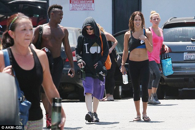 Street style: She covered up in an oversized black hoodie with the letter 'I' and an upside-down heart emblazoned on the front