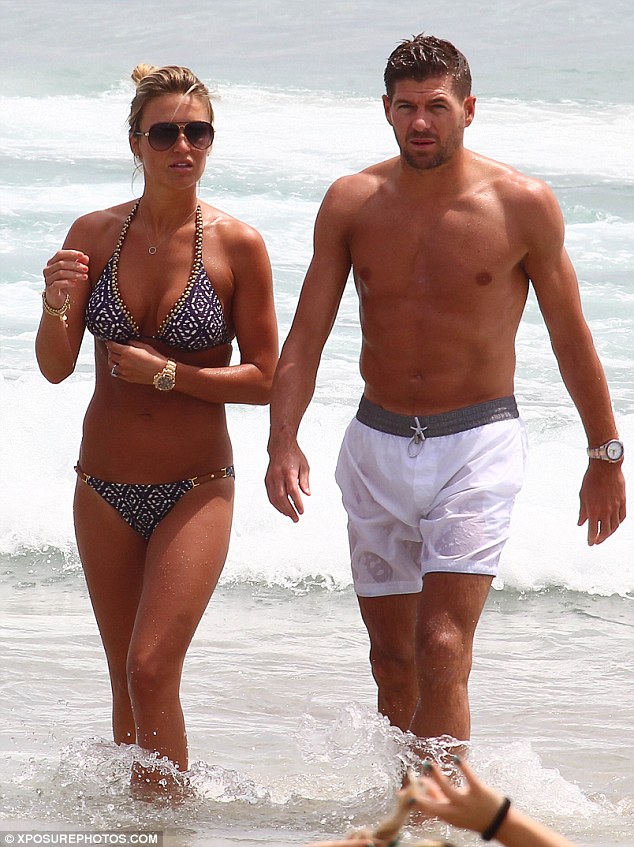Familiar faces: Steven Gerrard and his wife Alex enjoy a dip in the ocean on Wednesday