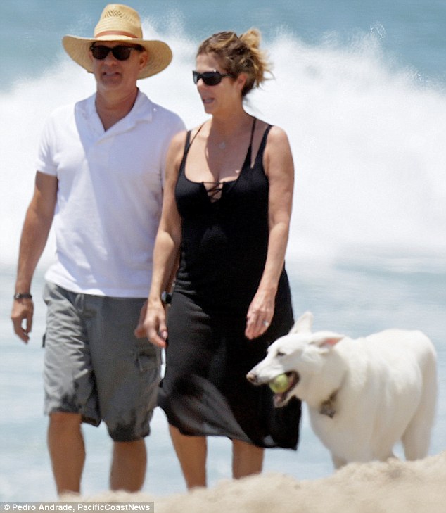 Best friends: Tom Hanks seemed to enjoy taking his dog and wife Rita Wilson for a walk in Malibu on Saturday