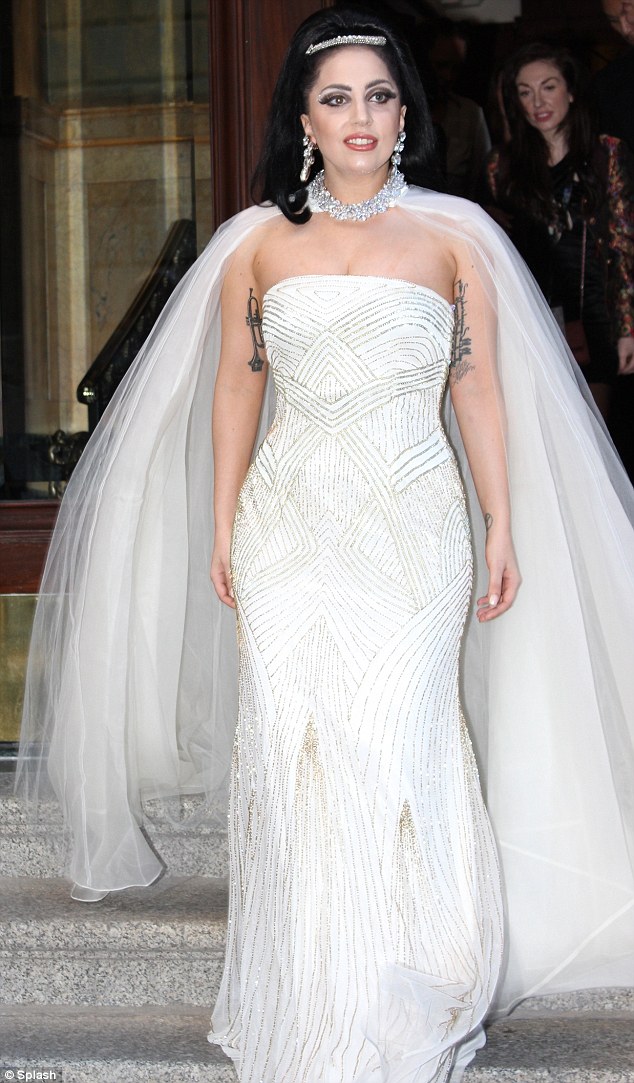 Here comes the bride! Lady Gaga stepped out in a bridal inspired dress as she left her hotel in Montreal on Tuesday