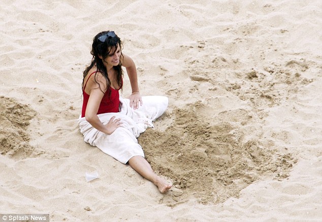 Doting mother: Penelope smiled proudly as she watched her son in the distance
