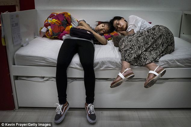 Tiring: Another pair of shattered shoppers flop over the flatpack furniture