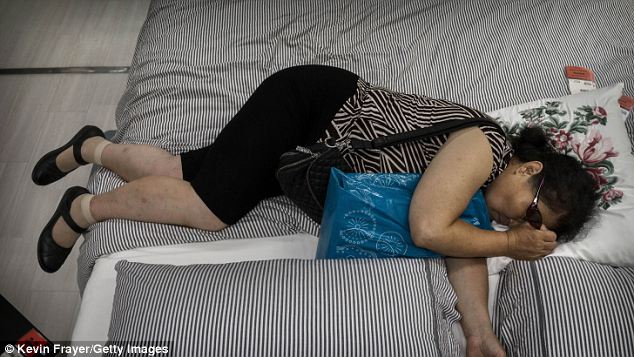 Cool: Most of the visitors have come to take advantage of the shop's air conditioning - an expensive luxury