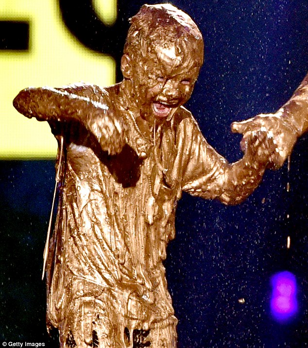 The golden child: But young Cruz looked anything but pleased after being covered in goo