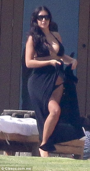 Specs appeal: She accessorised her look with a pair of oversized dark shades