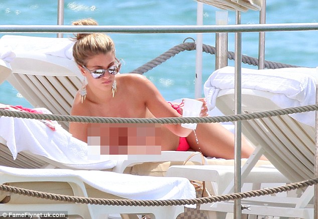 Fancy pants: Amy kicked back on the loungers at the prestigious InterContinental Carlton Hotel