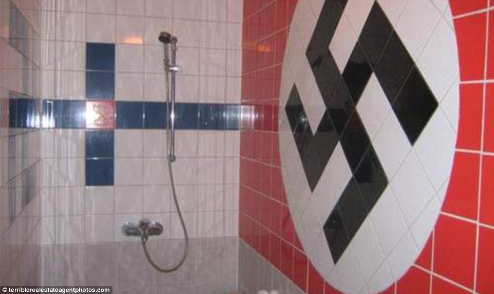 Sinister: In one estate agent's advert, the bathroom is shown decorated with a giant tiled swastika. All the images have been compiled on the blog terribleestateagentphotos.com