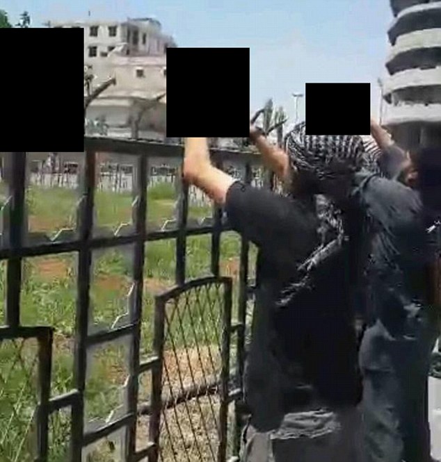 Disturbing: Sharrouf also posted a photo of two men placing severed heads on a metal railing