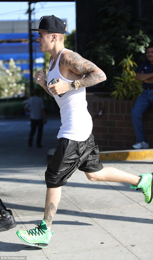 Bling: The singer was photographed sporting a very expensive watch and his mobile phone