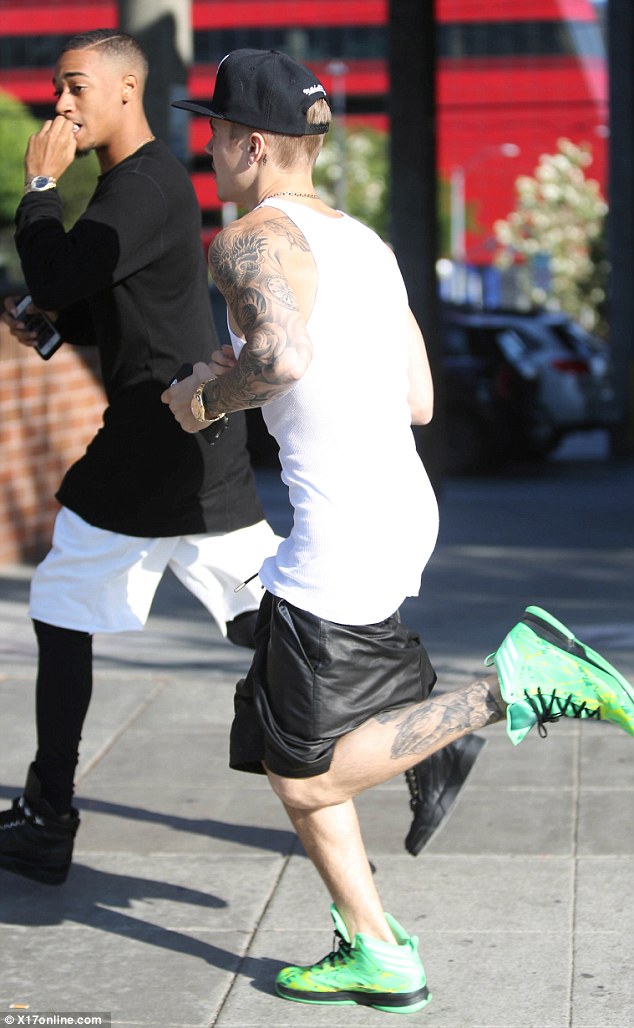 Trendy? The Canadian recording artist was wearing neon green shoes with basketball shorts and a tank top