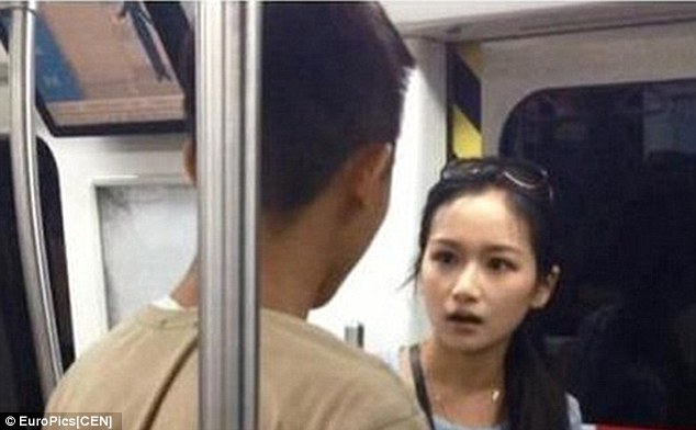 Put it down: The woman becomes increasingly annoyed at her boyfriend on the undergorund