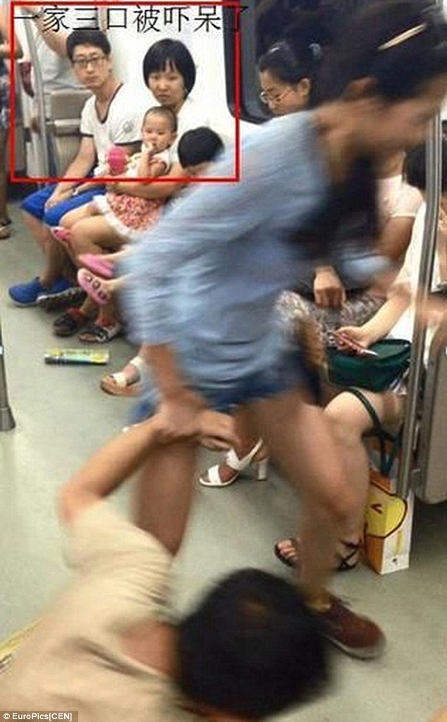 Drag and drop: The woman takes her boyfriend by the wrist and drags him out of the carriage
