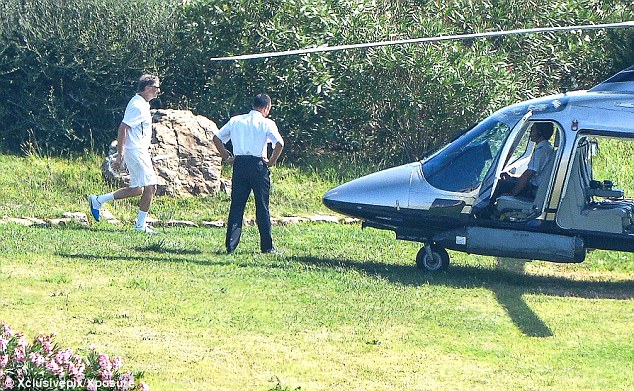 Your ride: Bill Gates gets ready to get inside his helicopter that will take him back to his rented yacht. In the past he has said that he does have guilty pleasure purchases - such as his own private plane