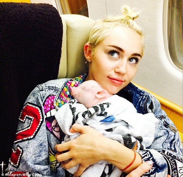 Love: The singer tapped into her maternal side as she coddled the young pig in a photo shared on Sunday