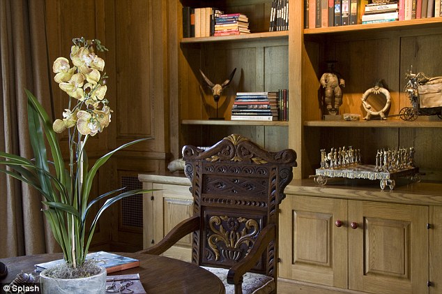 Rest and retreat: The library features built-in book cases filled with objects to inspire the comedian and thinker, including a hand carved chessboard, antiques and sculptures from around the world, and an extensive book collection