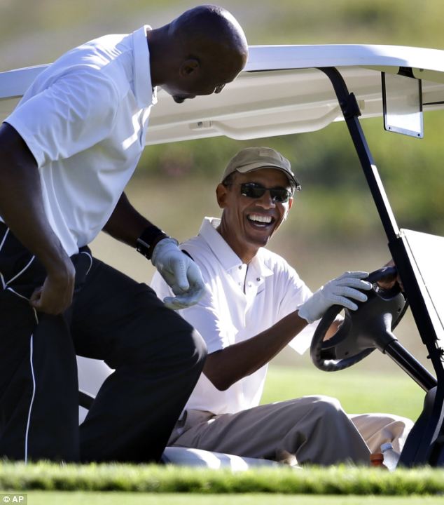 Obama, laughed with former NBA basketball player Alonzo Mourning (L) during his 7th round of golf on his current two-week vacation