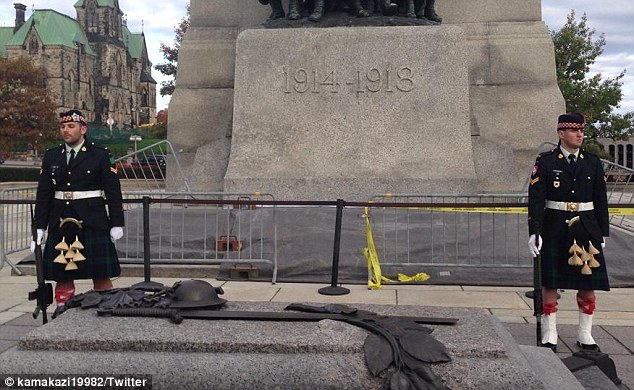 Seconds before: A tourist snapped this photo, likely the last one ever taken of Corporal Nathan Cirillo (left) before he was gunned down by Michael Zehaf-Bibeau in a horrific terroristic act on Ottowa's Parliament Hill on Wednesday