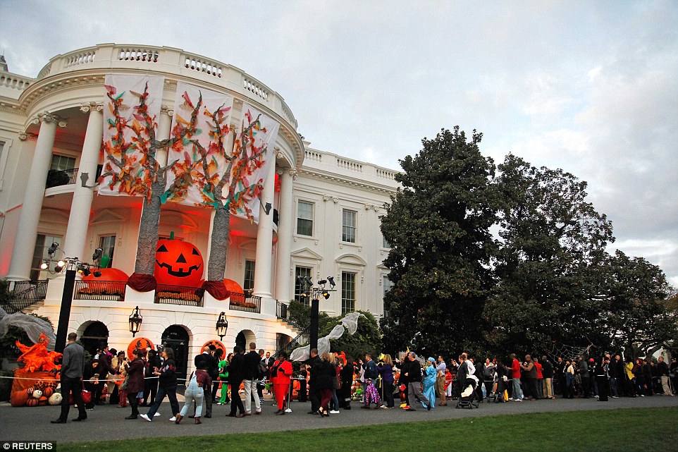 Waiting their turn: The line of trick-or-treaters (and their parents) spread way down the south lawn