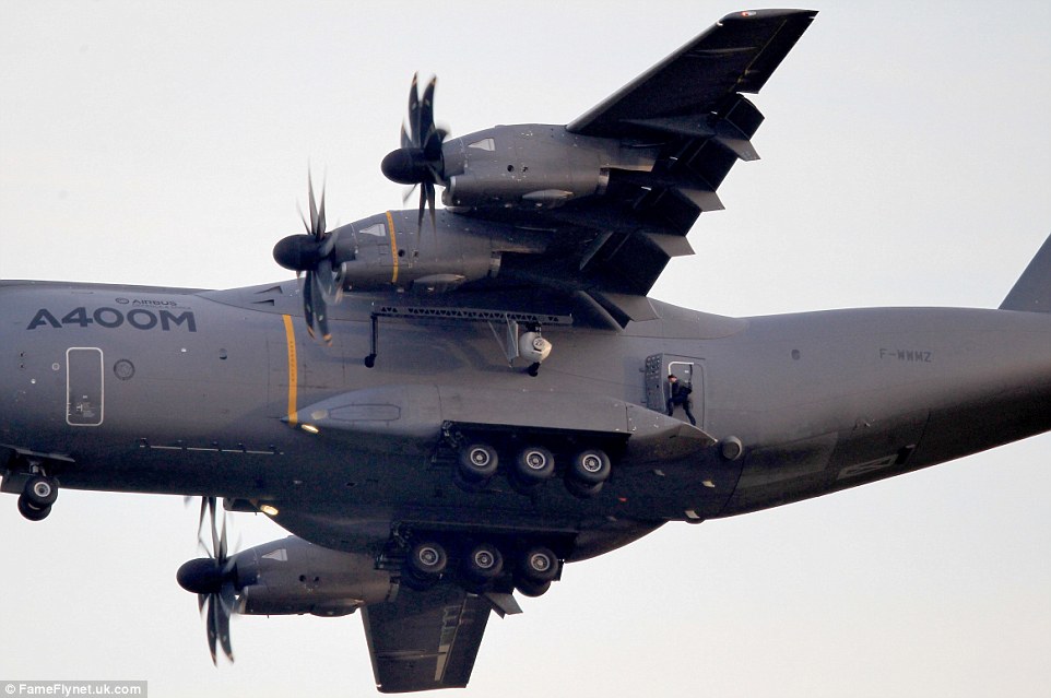 All his own work: Pictures show the actor at a terrifying height, strapped to the aircraft door with only two safety harnesses