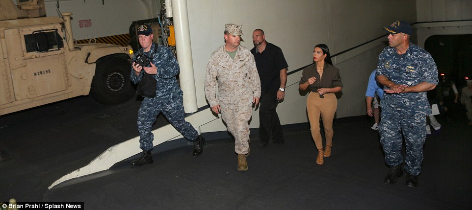Beauty on board: The 34-year-old was given the Royal treatment with a VIP escort around the ship. She donned a suitably camo colored outfit for the trip