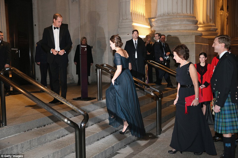 Beautiful: Kate lifts her dress up as she walks up the Metropolitan Museum of Art in front of fellow St Andrews alumni in red gowns