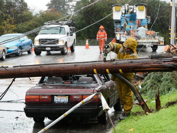 A Pacific Gas and Electric utilities crew remove power