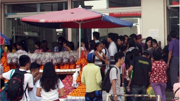 Residents at shops in Tacloban, Philippines (3 Dec 2014)