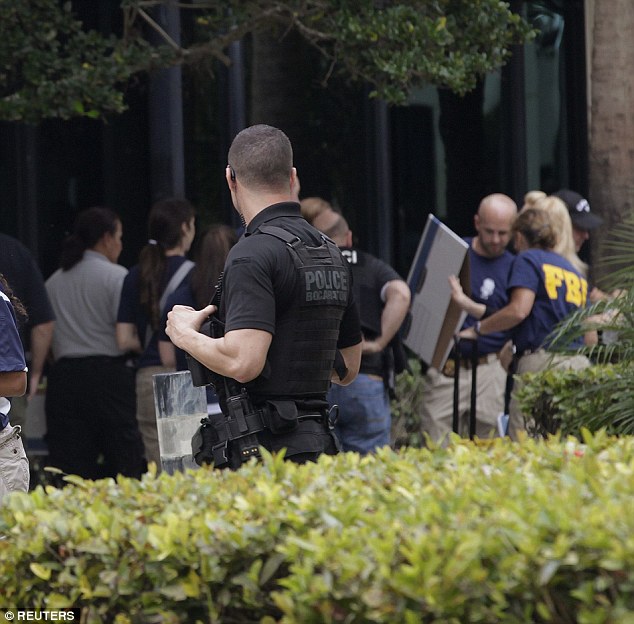 FBI agents walk outside the office in Boca Raton, Florida on Wednesday
