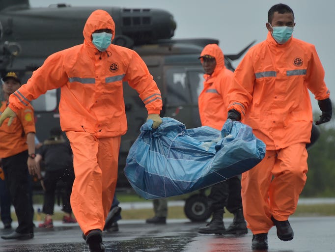 Members of an Indonesian search and rescue team carry