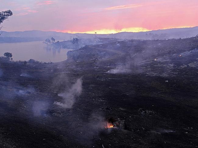 Desolation ... Embers glow against the smoke-filled sunset near Gumeracha in the Adelaide