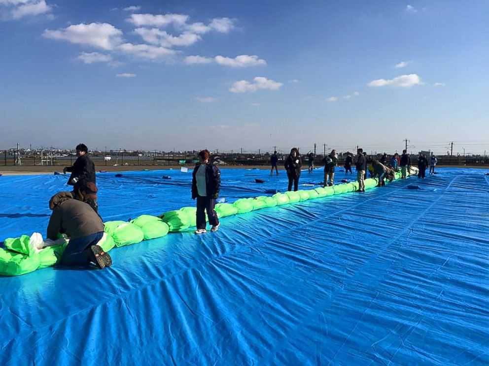 PHOTO: Japanese volunteers in Saga, Japan, help to ready the Two Eagles balloon for flight