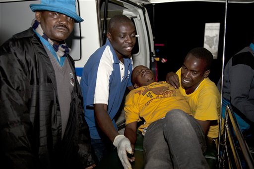 A survivor of a multi-story building collapse arrives for treatment at Kenyatta National Hospital in the capital Nairobi, Kenya, Sunday, Jan. 4, 2015. AP PHOTO/SAYYID AZIM