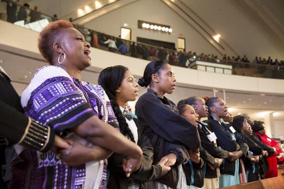 People sing 'We Shall Overcome' at the conclusion of The King Center's 47th Annual Martin Luther King Jr. Commemorative Service in Atlanta January 19, 2015. REUTERS-Christopher Aluka Berry