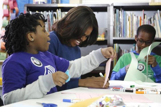 U.S. first lady Michelle Obama laughs as she works on a literacy project with children during a day of service at the Boys & Girls Club of Greater Washington, in celebration of the Martin Luther King, Jr. holiday in Washington January 19, 2015. REUTERS-Jonathan Ernst