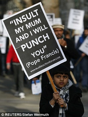 A young boy was among those carrying placards saying Insult My Mum And I Will Punch You – quoting the Pope in the wake of the Paris attacks