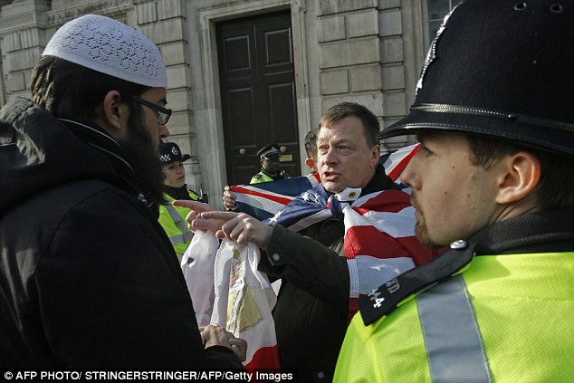 Clash: A nationalist demonstrator points his finger at one of the Muslim protesters earlier this afternoon
