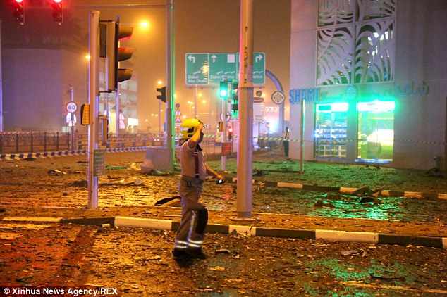 Destruction: High winds whipped through the area and debris from the fire cluttered nearby streets after the blaze appeared to be extinguished