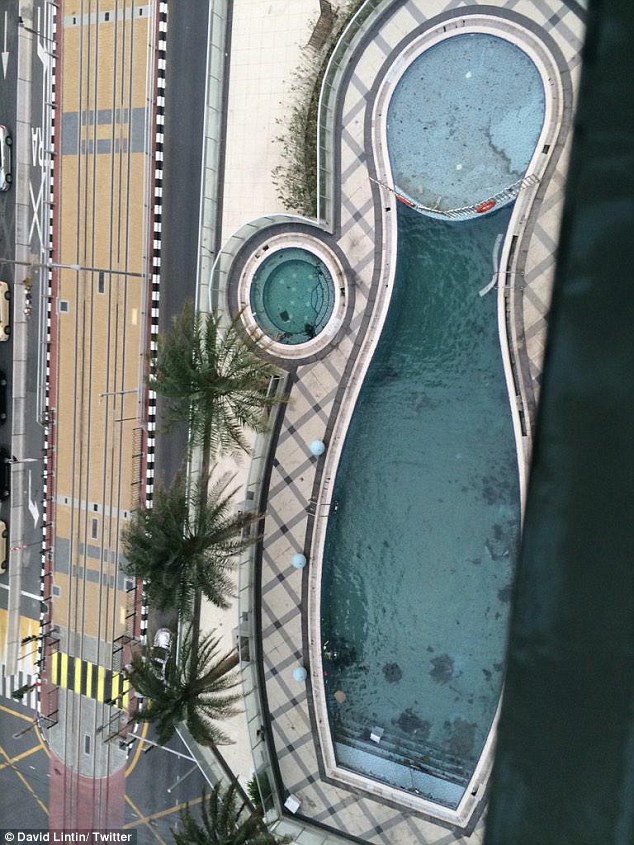 Off limits: One resident of the Marina Torch took this picture from his balcony - showing the charred debris polluting the building's outdoor pool