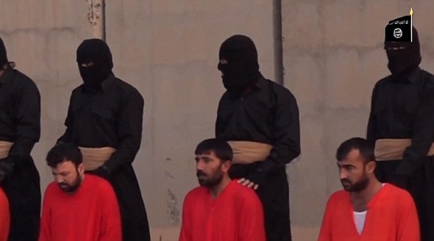 The hostages are seen bowing their heads as menacing militants carrying guns force them to their knees